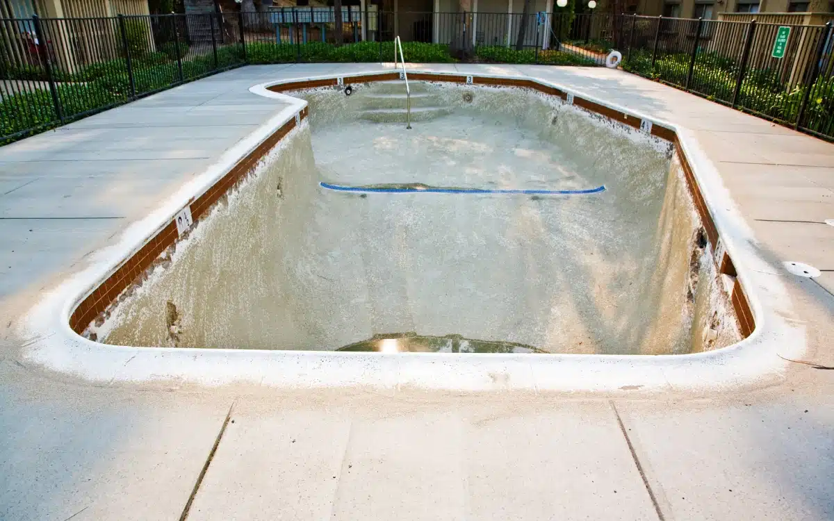 Empty concrete pool ready for removal