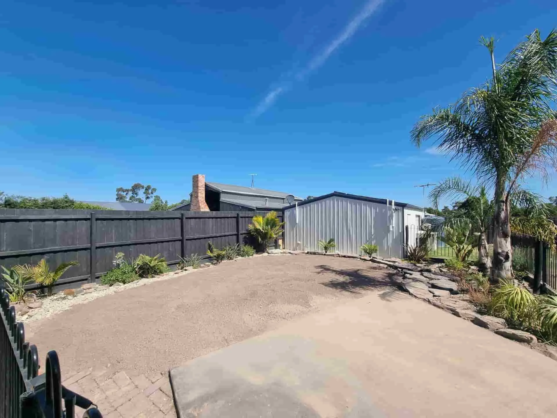 The same paved backyard after fibreglass pool removal